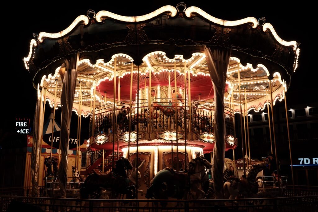 A carousel at night, with lights on.