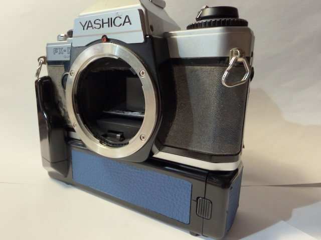 Yashica FX-D camera with motor drive and blue covering in place