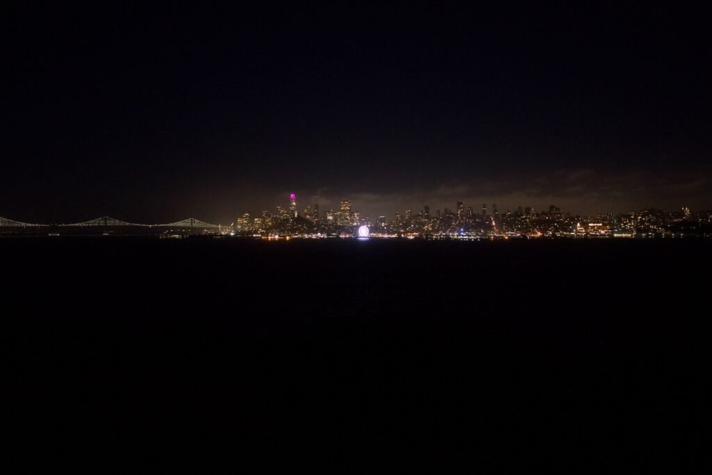 SF Bay bridge and SF skyline at night seen from Alcatraz.