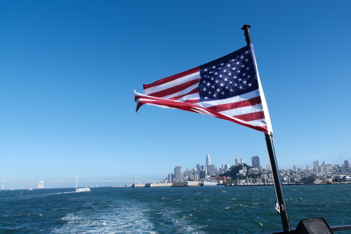 The Stars & Stripes flies on the back staff of a ferry.