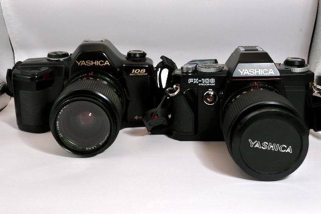 Yashica 108 Multi Program 35mm film camera at the side of the earlier FX-103 Program.